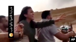 FILE - In this image from video, Noa Argamani reacts as she is seized by members of Hamas during the incursion into Israel on Oct. 7, 2023. The writing in Arabic at left in the video posted on social media reads, "Our guys have done their duty."
