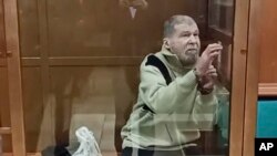 FILE - In this photo taken from video released by the Moscow City Court Press Service, Stephen Hubbard, a U.S. citizen accused of fighting as a mercenary in Ukraine, stands in a glass cage during a court session in the Moscow City Court on Oct. 7, 2024.