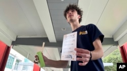 Jayden D'Onofrio passes out Plan B, condoms and rolling papers to educate young voters at Florida Atlantic University on April 11, 2024, in Boca Raton. Abortion and marijuana, issues young voters say are critical to them, will be on Florida's November ballot.