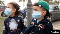 Kuwaiti kids wear protective face masks