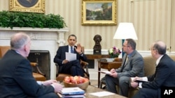 President Obama receives a briefing on the earthquake in Japan and the tsunami warnings across the Pacific, in the Oval Office of the White House, March 11, 2011