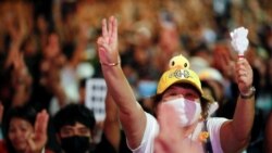 Pro-democracy activists show the three-finger salute as they protest after the constitutional court's ruling on Prime Minister Prayuth Chan-Ocha's conflict of interest case, in Bangkok, Thailand, Dec. 2, 2020.