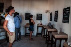 Copacabana Surf Village set up pacards to explain how the restaurant has reduced its waste. (A. Hammerschlag/VOA)