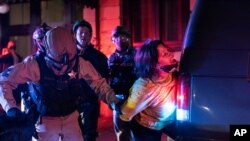 FILE - Police arrest a protester during clashes at a march following the presidential election Nov. 4, 2020, in Portland, Ore.