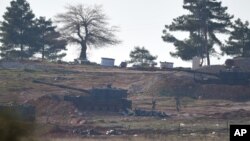 Soldiers carry ammunition as Turkish artillery fire from the border near Kilis toward northern Syria, in Kilis, Turkey, Feb. 15, 2016. 