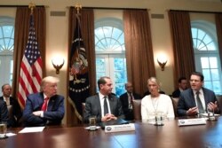 President Donald Trump listens to American Vaping Association President Greg Conley, right, during a meeting in the Cabinet Room of the White House in Washington, Nov. 22, 2019, on youth vaping and the electronic cigarette epidemic.