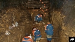 In this 2011 photo provided by Bence Viola of the University of Toronto, researchers excavate a cave for Denisovan fossils in the Altai Krai area of Russia. (Bence Viola/Department of Anthropology - University of Toronto/Max Planck Institute for Evolutionary Anthropology via AP)
