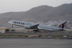 A Qatar Airways aircraft takes off with foreigners from the airport in Kabul, Afghanistan, Sept. 9, 2021, in the first such large-scale departure since U.S. and foreign forces concluded their frantic withdrawal from the country late last month.