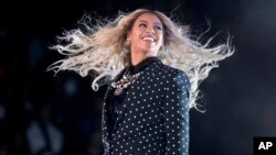FILE - Beyonce performs at a Get Out the Vote concert for Democratic presidential candidate Hillary Clinton in Cleveland.