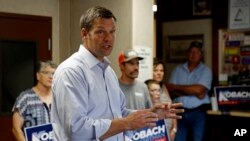 Kansas Secretary of State Kris Kobach and candidate for the Republican nomination for Kansas Governor addresses supporters during a campaign stop, Aug. 3, 2018, at the Fort Scott Livestock Market in Fort Scott, Kan. 