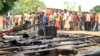 Suspected fighters are paraded before the media by Burundian police near a recovered cache of weapons after clashes in the capital, Bujumbura, Dec. 12, 2015. 