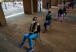 FILE - Off duty metro police officers queue to be screened and tested for COVID-19 in Johannesburg, South Africa, May 7, 2020.