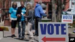 FILE - Electioneers greet voters outside the Hamilton County Government Center during early voting in Noblesville, Indiana, April 27, 2018