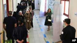 Warga Kuwait antre untuk memberikan suara dalam pemilu nasional pada Kamis (4/4). 