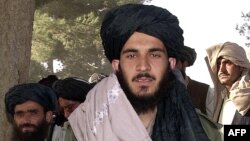 FILE - Tayyab Agha, the special assistant to Mullah Mohammad Omar, walks to a press conference in Spin Boldak, November 21, 2001.