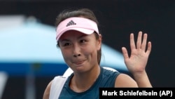 FILE - China's Peng Shuai waves after losing to Canada Eugenie Bouchard in their first round match at the Australian Open tennis championships in Melbourne, Australia on Jan. 15, 2019.