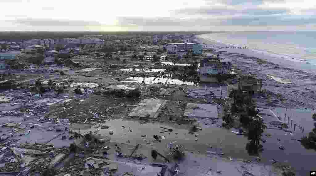  In this image made from video and provided by SevereStudios.com, damage from Hurricane Michael is seen in Mexico Beach, Fla. on Thursday, Oct. 11, 2018. Search-and-rescue teams fanned out across the Florida Panhandle to reach trapped people in Michael&#39;s wake Thursday as daylight yielded scenes of rows upon rows of houses smashed to pieces by the third-most powerful hurricane on record to hit the continental U.S. (SevereStudios.com via AP) 