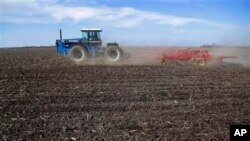 FILE - Central Illinois corn and soybean farmer cultivates field in preparation for spring planting, Waverly, Ill.