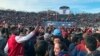 FILE - Student demonstrators stage a protest, in part against the continued use of fossile fuels, at a football game between Harvard and Yale in New Haven, Connecticut, Nov. 23, 2019. 