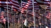 FILE - A young woman wearing a hijab stands amongst U.S. national flags erected by students and staff from Pepperdine University to honor the victims of the Sept. 11, 2001, attacks, at their campus in Malibu, California, Sept. 10, 2016.