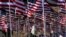 FILE - A young woman wearing a hijab stands amongst U.S. national flags erected by students and staff from Pepperdine University to honor the victims of the Sept. 11, 2001, attacks, at their campus in Malibu, California, Sept. 10, 2016.