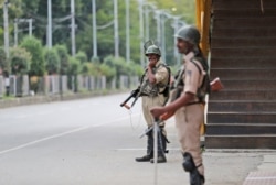 Indian paramilitary soldiers stand guard during a security lockdown in Srinagar, Indian-controlled Kashmir, Aug. 12, 2019.