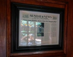A framed newspaper clipping hangs near the entrance of the Stonewall Inn in New York, June 14, 2019, headlining the 1969 riots. Some of the coverage of rioting was a source of fury that led Stonewall to become a synonym for the fight for gay rights.
