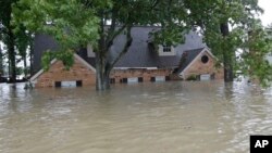 Sebuah rumah di Spring, Texas, terendam banjir akibat hantaman Badai Tropis Harvey, 28 Agustus 2017. (AP Photo/David J. Phillip)