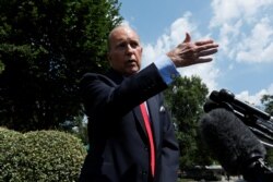 FILE - White House chief economic advisor Larry Kudlow speaks with reporters outside the West Wing of the White House in Washington, June 27, 2019.