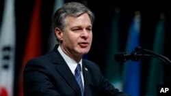 FILE - FBI Director Christopher Wray speaks during the FBI National Academy graduation ceremony, Dec. 15, 2017, in Quantico, Virginia.