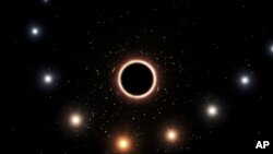 This artist's impression provided by the European Southern Observatory in July 2018 shows the path of the star S2 as it passes close to the supermassive black hole at the center of the Milky Way galaxy. 