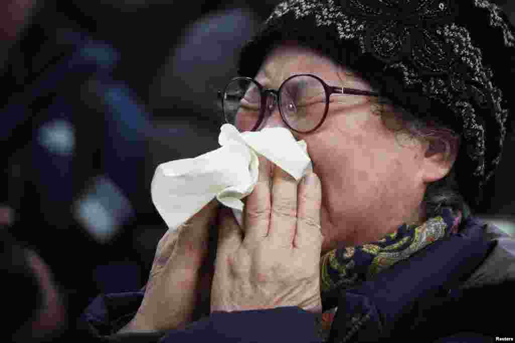 A relative of a passenger of the aircraft that crashed after it went off the runway reacts at Muan International Airport, Dec. 29, 2024.