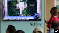 FILE - A TV screen shows a satellite image of a North Korean missile launch site, during a news program at the Seoul Railway Station in Seoul, South Korea, July 24, 2018. 
