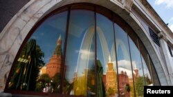 The walls and towers of the Kremlin are reflected in a window of a closed McDonald's restaurant, one of four temporarily closed by the state food safety watchdog, in Moscow, August 21, 2014. Russia ordered the temporary closure of four McDonald's restaura