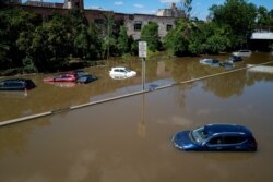 FILE - Cars and trucks are stranded by high water, Sept. 2, 2021, on the Major Deegan Expressway in Bronx borough of New York as high water left behind by Hurricane Ida still stands on the highway hours later.