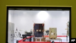 In this photo provided Saturday, Aug. 31, 2019, by Iran's Information and Communications Technology, The Nahid-1 domestically-built satellite is displayed at the space research center in Tehran, Iran. 
