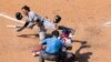 Miami Marlins' Miguel Rojas, left, reacts to getting hit by a pitch during the seventh inning of a baseball game, July 26, 2020, in Philadelphia. 