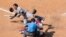 Miami Marlins' Miguel Rojas, left, reacts to getting hit by a pitch during the seventh inning of a baseball game, July 26, 2020, in Philadelphia. 