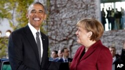 U.S. President Barack Obama, left, is welcomed by German Chancellor Angela Merkel prior to a meeting of the government heads of Germany, France, Italy, Spain and Britain in Berlin, Nov. 18, 2016.