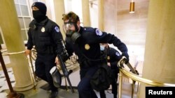 U.S. Capitol police officers take positions as protestors enter the Capitol building during a joint session of Congress to certify the 2020 election results on Capitol Hill in Washington, Jan. 6, 2021.