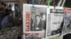 Georgians read newspapers on the street in Tbilisi, Georgia, October 2, 2012.