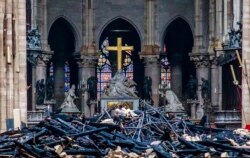 Debris are seen inside Notre Dame cathedral in Paris, April 16, 2019.