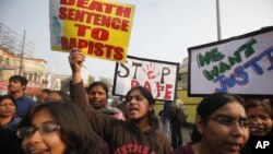 ndian students protesting against the brutal gang-rape of a woman on a bus last week in New Delhi, hold placards during a protest in Allahabad, India, Dec. 26, 2012