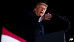 FILE - President Donald Trump speaks during a campaign rally for Georgia Sens. Kelly Loeffler and David Perdue, at Dalton Regional Airport, Jan. 4, 2021, in Dalton, Ga.