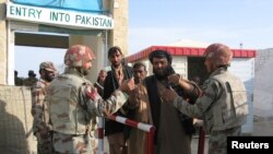 Pakistani soldiers check the identity of citizens returning from Afghanistan at the border town of Chaman, Pakistan, March 7, 2017. 