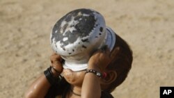 Two-year-old Hawal drinks water in a relief camp for flood victims in Thatta, some 100 km from Karachi in Pakistan's Sindh province October 24, 2010.
