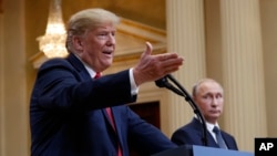 FILE - U.S. President Donald Trump gestures as Russian President Vladimir Putin looks on in Helsinki, Finland, July 16, 2018.