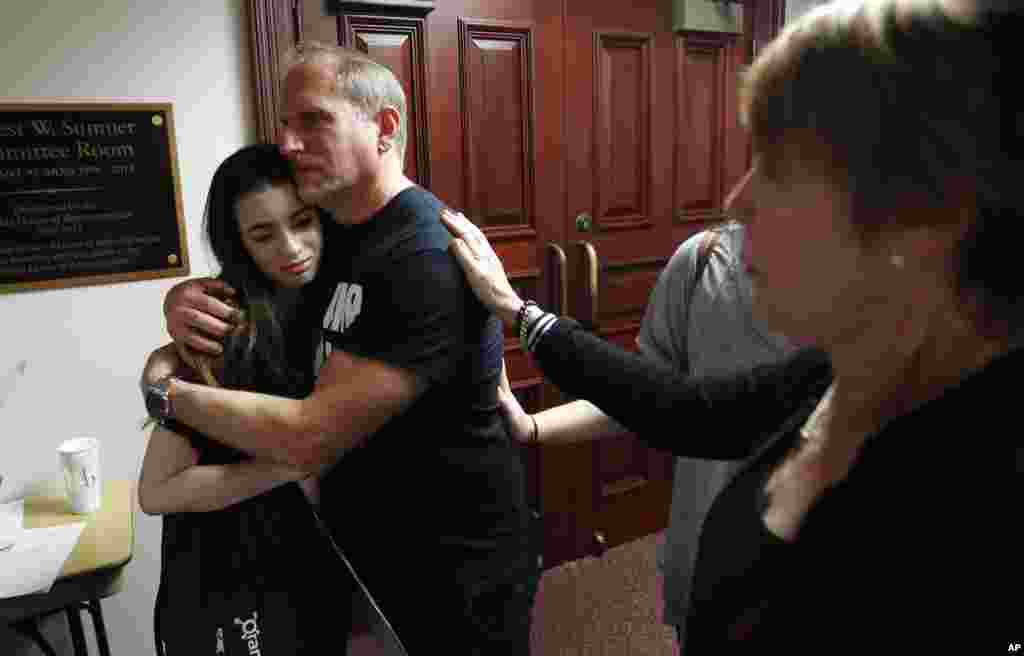 Rabbi Bradd Boxman of Congregation Kol Tikvah, hugs Aria Siccone, 14, a 9th grade student survivor from Marjory Stoneman Douglas High School.