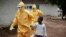 Health workers accompany a nine-year-old who contracted the Ebola virus to a Monrovia treatment center.