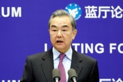 FILE - Chinese Foreign Minister Wang Yi delivers a speech in Beijing, Feb. 22, 2021.